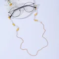 Detailed view of a gold chain for glasses with white pearls and yellow enamel butterflies - Butterfly Yellow