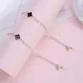 Black four-leaf clover eyewear chain with white pearls and gold-plated lobster clasps - Brown