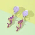 Detailed view of mermaid clip-on earrings with purple enamel and soft protective pads - Mermaid