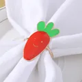 Dettaglio dell'anello portatovagliolo a forma di carota sorridente su tovagliolo bianco - Forma a Carota