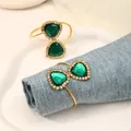 Golden napkin rings with heart-shaped emerald green crystals and zircon accents - Green