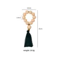 Détail du rond de serviette en perles de bois avec pompon vert et dimensions 15x5,5 cm - Anneau Perles Bois Motif Gland Vert (Z1204)