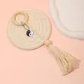 Bohemian napkin ring featuring a wood loop, white cotton tassel, and Yin Yang charm - Z1203