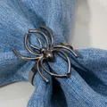 Metallic spider-shaped napkin ring in gun black finish for elegant table settings - Black