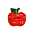 Detailed macro view of red enamel apple brooch with TEACH LOVE INSPIRE golden lettering - Teach Love Inspire Design