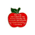 Close-up of red enamel apple brooch with gold leaf and engraved teacher quote - Big Heart Minds Design