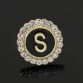 Golden round rhinestone brooch with black enamel inlay and gold letter S detail - C2173-S Brooch