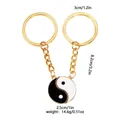 Golden alloy Yin Yang puzzle keychain set for couples featuring black and white charms - Gold Black & White(D1385-3-GO)