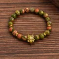 Detailed macro of unakite stone beads and gold alloy wolf head on beaded bracelet - Wolf Head Unakite Style (G1291-1)