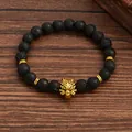 Black lava stone beaded bracelet with golden wolf head charm on dark wooden background - Wolf Head Lava Stone Style (G1291-2)