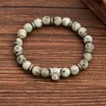 Natural 8mm spotted stone bead bracelet featuring a silver leopard head charm on wood - Leopard Head Dalmation Jasper Style (G1291-12)