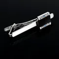 Detail of silver necktie clip with black matte inlay and blue crystals on dark mirror - T1030 Tie Clip