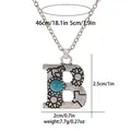 Detail of vintage silver letter B pendant with turquoise and western engraved motifs - A3217-B