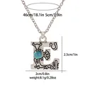 Detail of letter E turquoise pendant with engraved western motifs and size dimensions - A3217-E