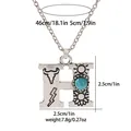 Detailed view of vintage silver 'H' pendant necklace with turquoise and western motifs - A3217-H