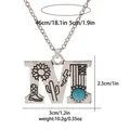 Detailed view of silver letter M pendant with turquoise and western carvings - A3217-M