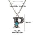 Detailed view of vintage letter P pendant with turquoise stone and bohemian carvings - A3217-P