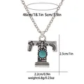 Detail view of vintage T-letter pendant with turquoise and tribal engravings on chain - A3217-T