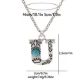 Detail of retro silver U-letter necklace with turquoise inlay and ornate bird engravings - A3217-U