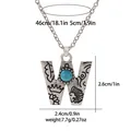Detail of bohemian silver letter W pendant with turquoise inlay and tribal carvings - A3217-W