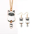 Detailed view of gold alloy cat pendant and hook earrings with white enamel finish - White Cat Necklace Earring Set (A3178-12)