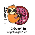 Detailed view of enamel sloth brooch holding a donut with 2.6cm dimensions and weight info - Sloth Hugging Donut (C2619-5)