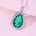 Close-up of teardrop green gemstone pendant with white crystals on a silver snake chain - Green (A2838-5)