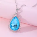 Macro view of blue pear-cut crystal pendant with lace-edged silver metal frame - Sky Blue (A2839-1)