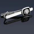 Detail of silver tie clip with embossed lion head motif on a black square base - Silver Lion Tie Clip