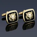 Macro detail of gold-tone cufflinks featuring a 3D lion head relief and black enamel finish - Gold Lion Head Cufflinks