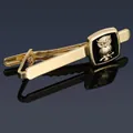 Macro view of gold-tone owl necktie clip with black background and mirror reflection - Gold Owl Tie Clip