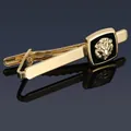 Detailed view of golden tie clip with lion head emblem on black square backing - Gold Lion Head Tie Clip