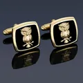 Macro view of gold cufflinks featuring 3D owl relief on black enamel surface - Gold Owl Cufflinks