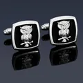 Macro shot of silver owl cufflinks with black inlay and detailed feather textures - Silver Owl Cufflinks