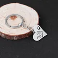 Macro view of heart-shaped keychain with You Had me At Woof text and paw print engraving - You Had me At Woof Heart Keychain (D1132)