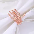 Detail of rose gold skeleton hand napkin ring with realistic bone texture for table decor - Rose Gold Skull Hand (Z1057-3)