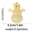 Detailed view of snowman brooch with dimensions 5.3cm by 4.2cm in sparkling rhinestones - Gold