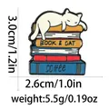 Cute enamel pin featuring a white cat lying on colorful books with size and weight specs - White Cat Lying On Books