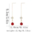 Dettaglio di orecchini a catena oro rosa con fiocco e sfera rossa con pavé, 9,3 cm - Stile Palla Shambhala Fiocco Oro Rosa (F1570-2)