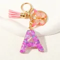 Purple resin letter A keychain with glitter, pink tassel and golden butterfly charm - Alphabet A (D1414-A)