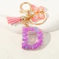 Macro detail of purple sequin letter D keychain with butterfly and pink tassel - Alphabet D (D1414-D)
