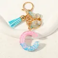 Letter C resin keychain with blue and pink glitter stars, tassel and golden butterfly - Letter C (D1417-C)