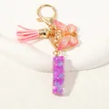 Portachiavi chic con paillettes viola con nappa rosa e ciondolo a farfalla - Alfabeto I (D1414-I)