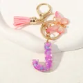 Portachiavi lettera J in resina viola con nappa rosa, paillettes a cuore e chiusura dorata - Alfabeto J (D1414-J)
