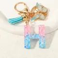 Letter H glitter resin keychain with pink blue gradient and gold butterfly charm - Letter H (D1417-H)