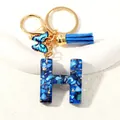 Blue resin alphabet H keychain with butterfly charm and blue tassel on gold hardware - Letter H (D1413-H)
