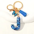 Blue resin letter J keychain with gold flakes, tassel and butterfly charm accessory - Letter J (D1413-J)
