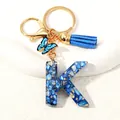 Blue resin letter K keychain with butterfly charm and matching tassel accessory - Letter K (D1413-K)