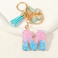 Glitter resin letter M keychain with blue tassel and gold butterfly charm accessory - Letter M (D1417-M)