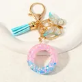 Letter O keychain with pink and blue glitter resin, light blue tassel and butterfly - Letter O (D1417-O)